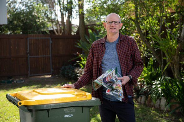 David Sawers recycling paper in his yellow bin