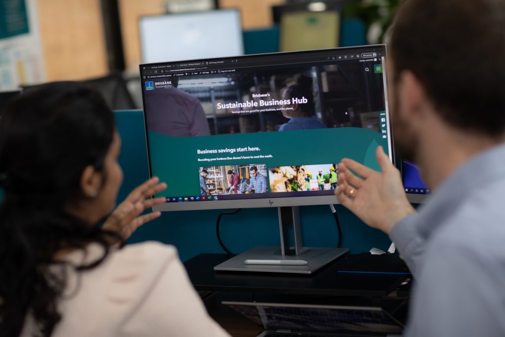 Over-the-shoulder shot of office workers viewing Sustainable Business Hub website