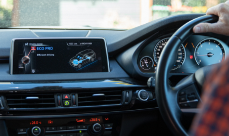 Shot of car dashboard on eco-driving setting as man drives