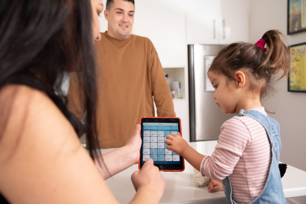 Carly Jackson showing her daughter their smart-home control interface.