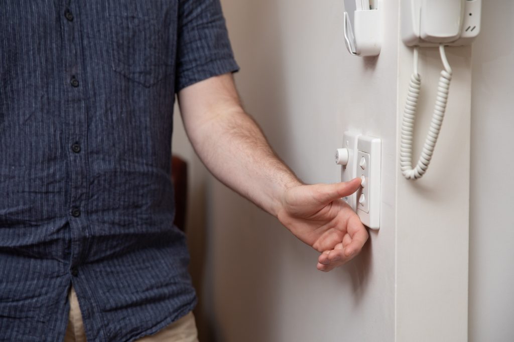 Close up shot of Finn's hand flicking off light switch