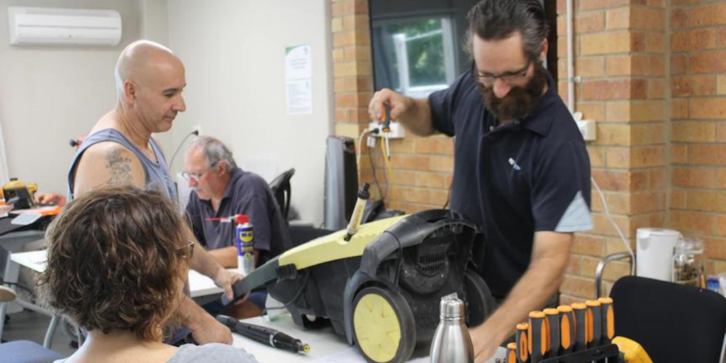 Redcliffe Repair Cafe volunteer fixing a customers pressure hose