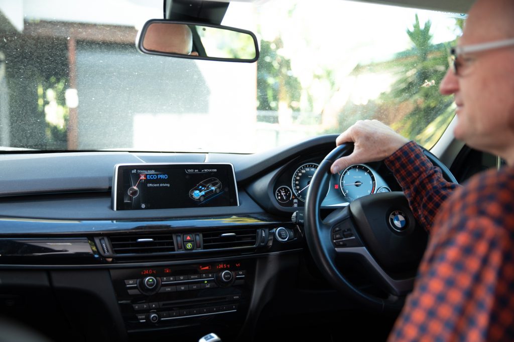 Over-the-shoulder shot of David Sawers driving his car on 'eco-mode'