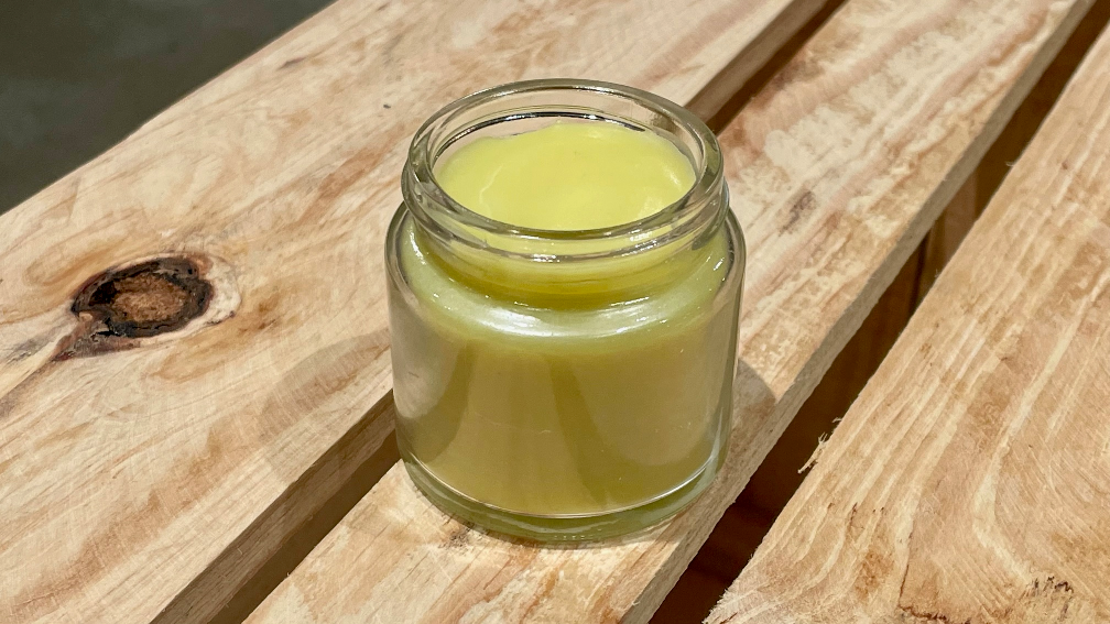 A glass jar of lip balm