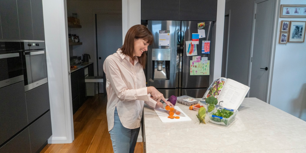 Lady cutting up vegetables