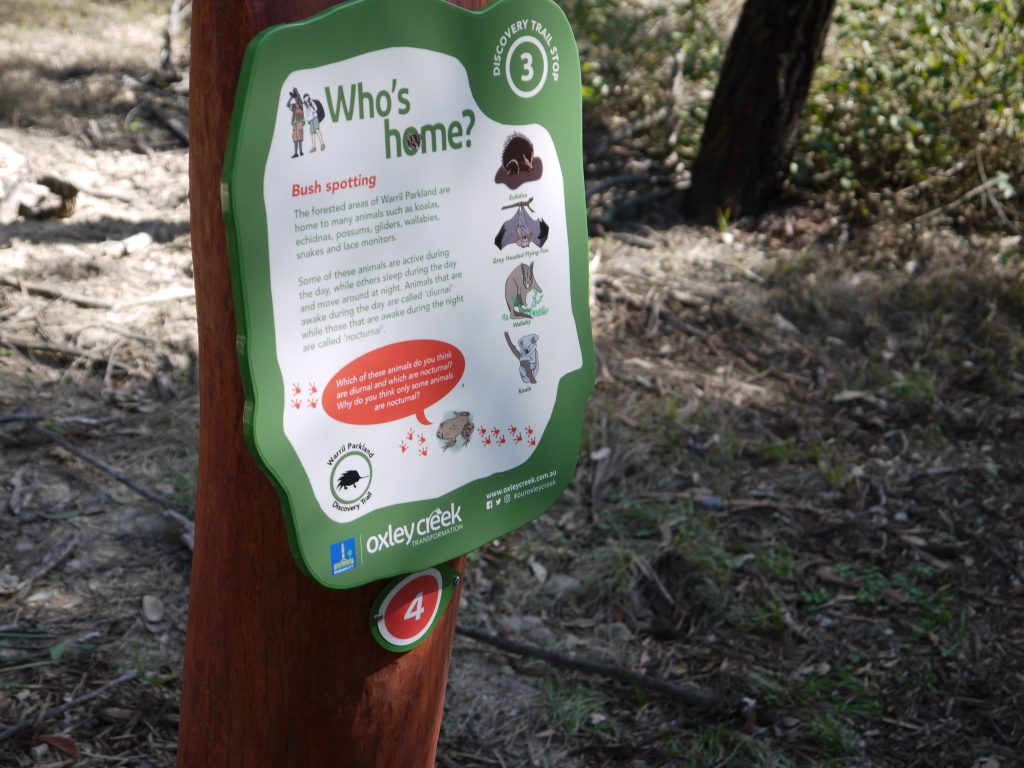 Signage about wild animals attached to a tree