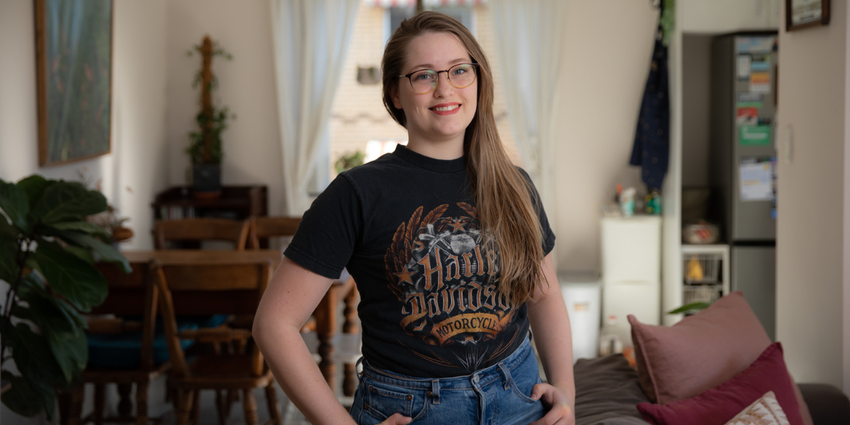 Alexandra standing in her living room, smiling looking into the camera.