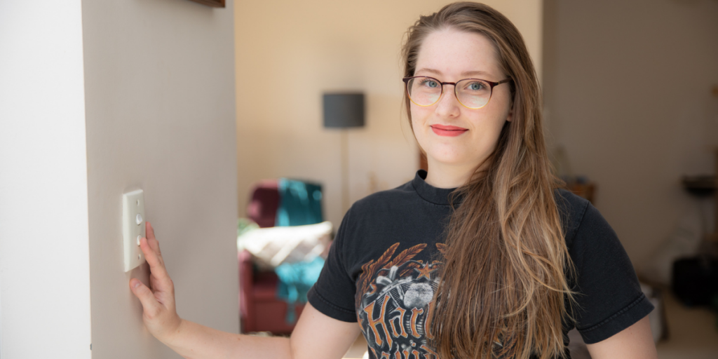 Alexandra Shepherd switching off a light switch in her home