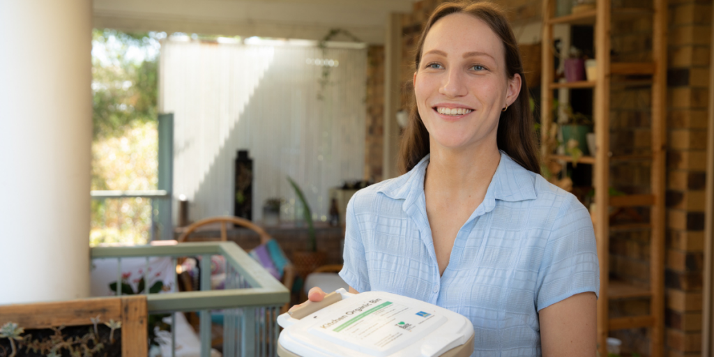 Laura Ferris holding bokashi bin