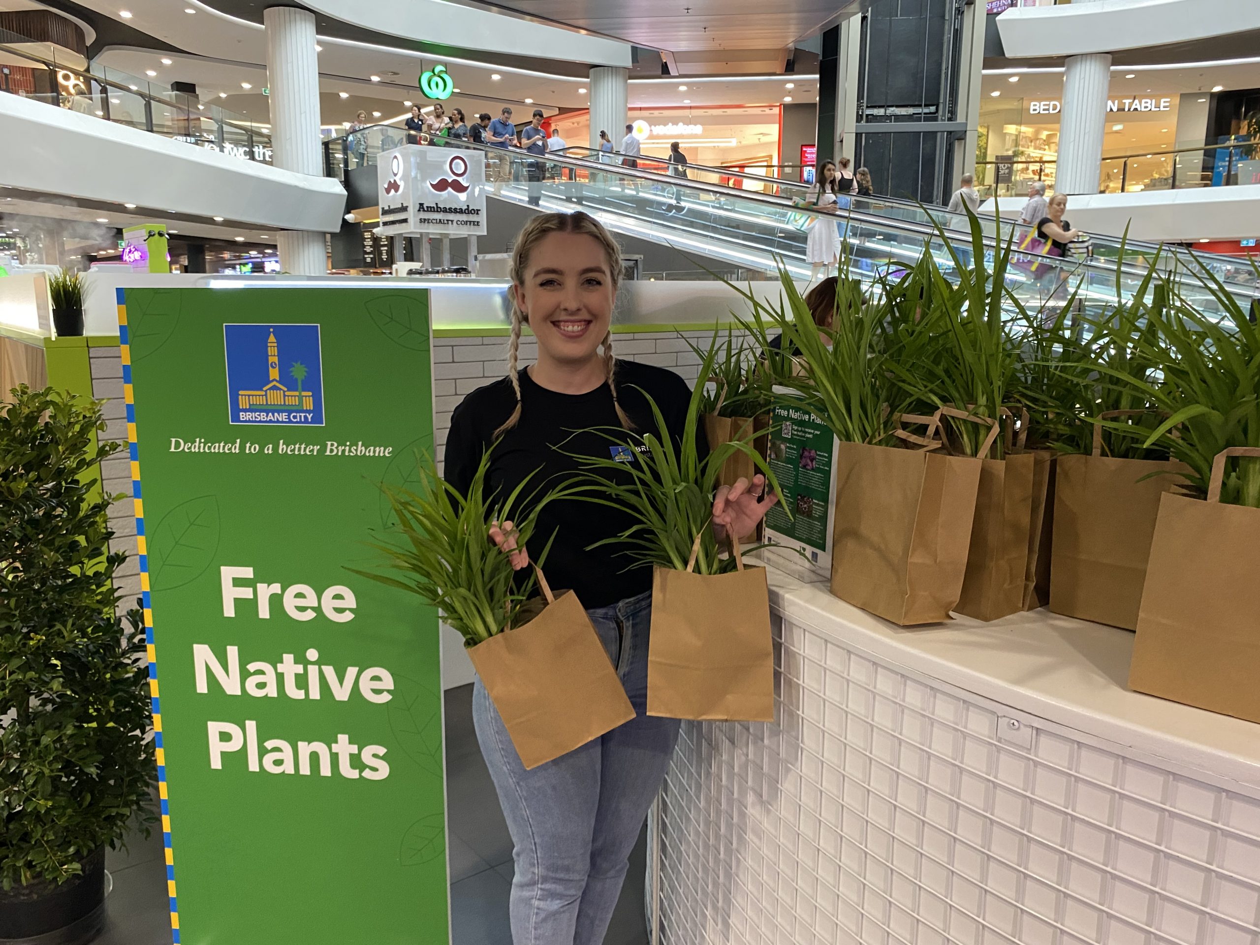 Lady holding plants at a stall